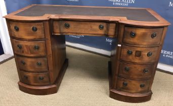 A late Victorian mahogany breakfront double pedestal desk,