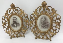 A pair of late 19th Century cast gilt brass photograph frames in the Rococo taste with all-over
