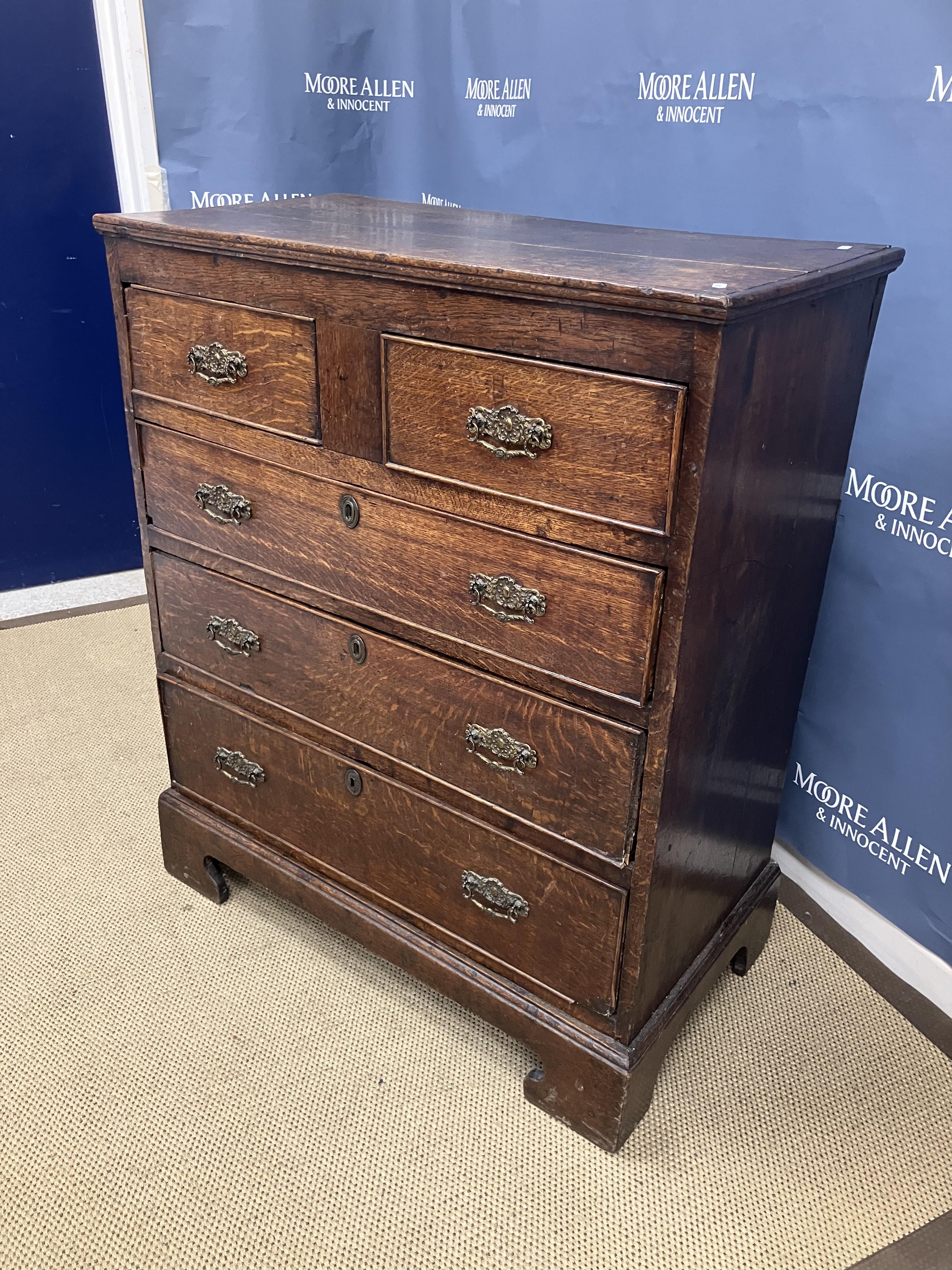 A 19th Century Provincial oak chest of two short over three long drawers with ornate brass drop - Image 2 of 2