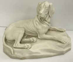 A 19th Century Copeland parian figure of a bloodhound recumbant on a rocky base 29.