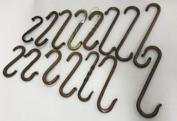 A collection of fifteen vintage copper and brass double ended hooks, largest approx. 24.