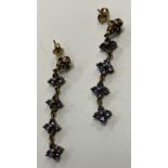 A pair of 9 carat gold Iolite (cordierite/water sapphire) mounted drop earrings of flower head form