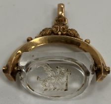 A 19th Century yellow metal mounted rock crystal seal decorated to one side with dragon and axe,