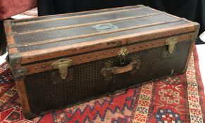 A circa 1930s Moynat of Paris leather, wood and brass bound trunk with twin side carry handles,