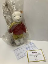 A Steiff by Danbury Mint Rupert Bear soft toy in yellow check trousers and matching scarf with red