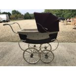 A Wilson pram with cream body and brown covers together with a child's vintage Silver Cross toy