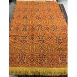 A Spectrum bouclé tweed style bed cover in yellow, tangerine and raspberry,