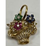 An 18 carat gold mounted brooch/pendant as a basket of flowers set with diamonds, rubies,