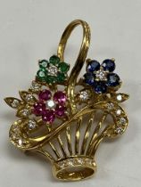 An 18 carat gold mounted brooch/pendant as a basket of flowers set with diamonds, rubies,