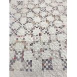 Three circa 1900 quilts comprising one hand-stitched patchwork quilt with white ground and