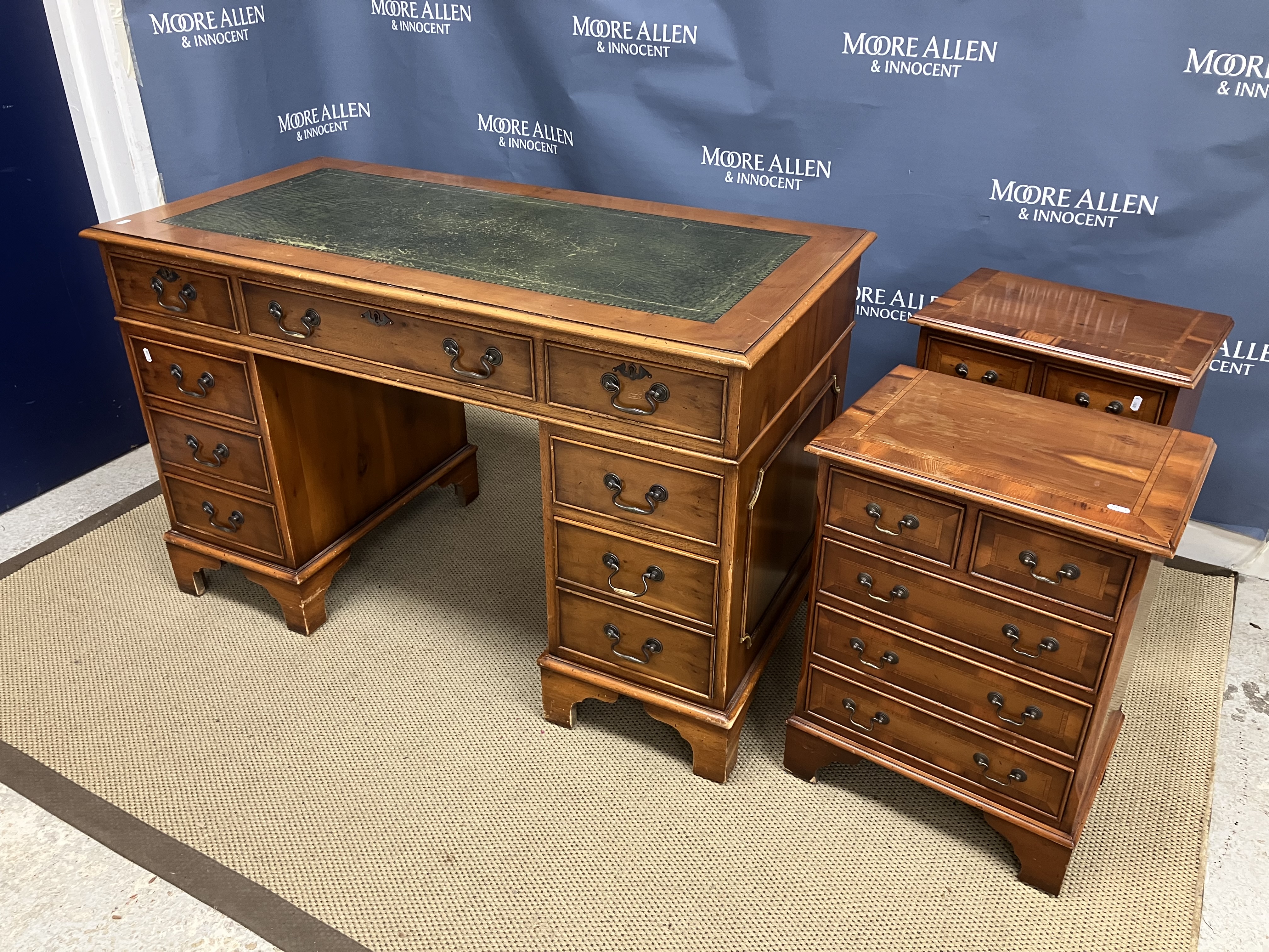 A pair of modern yew wood and cross banded miniature chests of two short over three long graduated