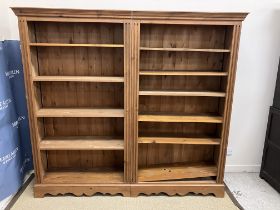 A modern pine two section bookcase in the 19th Century manner,