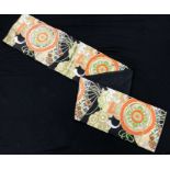 A late 20th Century Japanese obi belt with orange, green, white and gold fan and floral decoration,