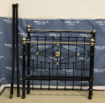 A late Victorian brass and iron three quarter bed stead with embossed roundel decoration to the