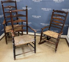 A pair of 19th Century ash rush seat ladder back elbow chairs and a similar rush seat rocking elbow