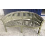 A slatted garden bench of bow back form 86 cm high x 150 cm long x approx.