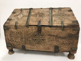 A vintage Indian Mughal dowry chest with carved medallion and brass bound decoration,