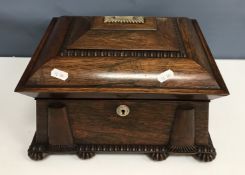 An early 19th Century rosewood sewing box of sarcophagus form,