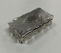 An early 19th Century French silver rectangular snuff box with engraved decoration and serpentine