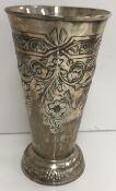 A George V silver embossed vase of flared cylindrical form with embossed floral and bird decoration