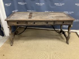 An Oka stained pine writing table in the 18th Century Spanish taste the plank top over three