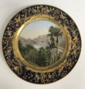 An Ernst Wahliss cabinet plate depicting a landscape scene within a cobalt blue and gilt bird and
