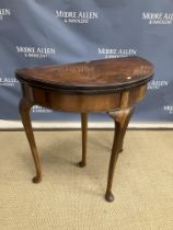An early to mid 20th Century burr walnut foldover cardtable of demilune form the top opening to