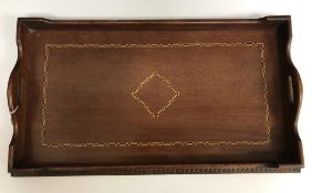 An Edwardian mahogany satinwood and ebony banded two handled drinks tray within a lotus leaf carved