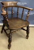 A Victorian beech and elm spindle back smoker's bow chair on heavy turned and ringed legs united by