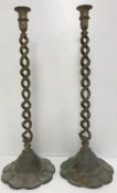 A pair of brass open barley-twist candlesticks on flower head textured foot, 56.
