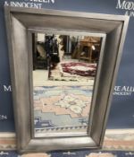 A modern silvered framed rectangular wall mirror 64 cm x 95 cm and a similar oval one (2)