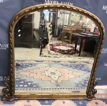 A 20th Century ribbon carved giltwood and gesso framed dome top over mantel mirror in the 19th