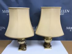 A pair of brass lion mask decorated table lamps in the Empire style raised on a square foot 26 cm