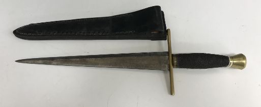 A 20th Century Templar dagger/side piece with rope work grip to the brass handle and tapered blade,