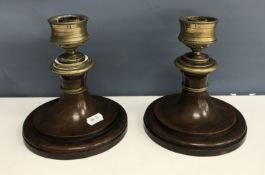 A pair of 19th Century brass and treen ware squat table candlesticks, 15 cm diameter x 16.