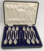 A George V silver set of twelve teaspoons and sugar tongs (by Charles Boyton & Sons Sheffield 1920),