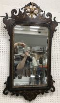 A walnut fretwork carved wall mirror with hoho bird finial in the 18th Century manner 52 cm wide x