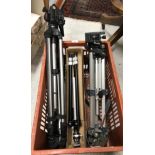 A crate containing various camera tripods