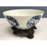 A 19th Century Chinese blue and white four toed dragon medallion decorated bowl raised on a