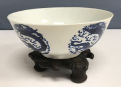 A 19th Century Chinese blue and white four toed dragon medallion decorated bowl raised on a