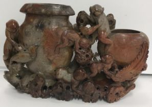 A Chinese soapstone double vase decorated with clambering monkeys and exotic bird amongst foliage,