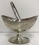 A Victorian silver sugar basket of rope shaped form with engraved floral swag decoration and beaded