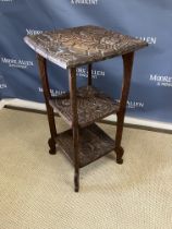 A Liberty carved teak rectangular three tier occasional table with all over foliate and floral