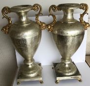 A pair of plated decorative urns in the Classical taste with engraved swag decoration and gilt