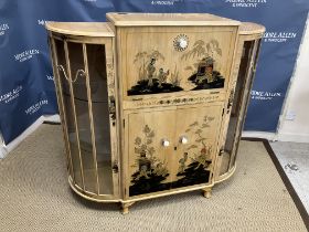 A mid 20th Century walnut and chinoiserie decorated cocktail cabinet of bow fronted outline,