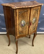 A 20th Century burr walnut side cabinet in the Louis XV taste the serpentine fronted top over two