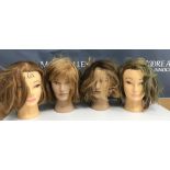 A collection of four mannequin/hairdressing heads,