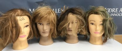 A collection of four mannequin/hairdressing heads,