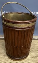 A 20th Century mahogany peat bucket in the Georgian style with brass rope twist swing handle and