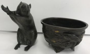 A Japanese bronze figure of a rat seated upon his haunches, arms held aloft,